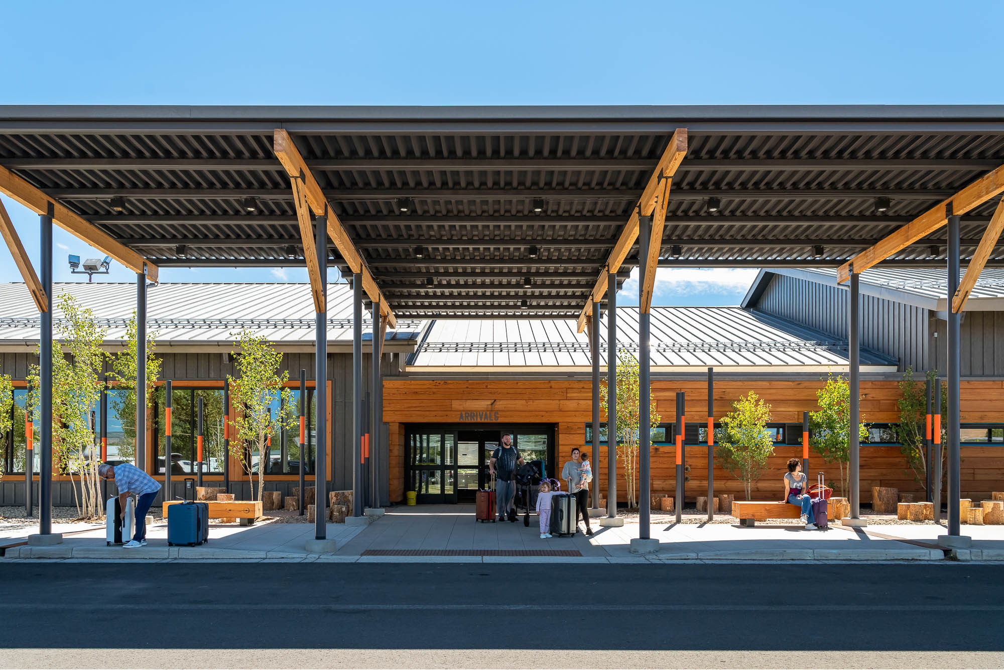 Travelers with luggage at Gunnison Airport arrivals